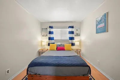 a bedroom with a bed and two night stands at Spacious 5 Bedroom Home Near Disneyland & Knotts with Jacuzzi Spa in Norwalk
