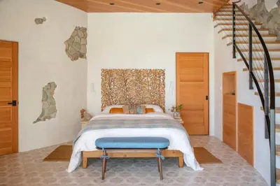 a bedroom with a large bed with a blue bench at Paradise De Rocas Antiguas in Los Angeles