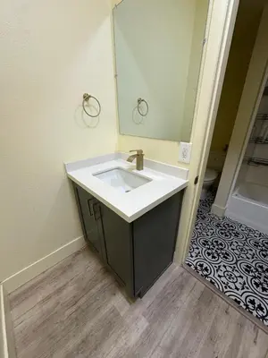 a bathroom with a sink and a mirror at Shared room, Prime Location LA in Los Angeles