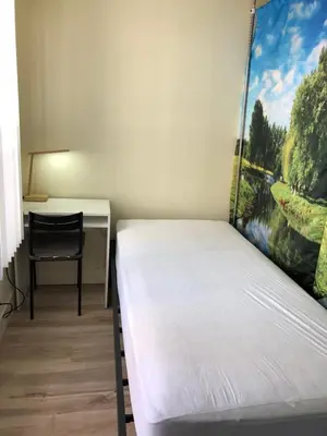 a room with a bed and a desk and a chair at Shared room, Prime Location LA in Los Angeles