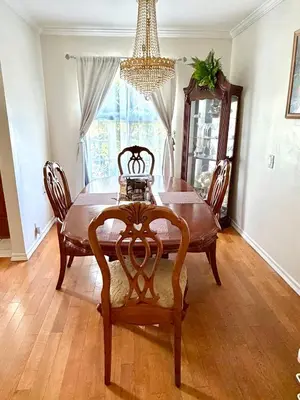 a dining room table with chairs and a chandelier at Dream House Retreat LLC in Los Angeles