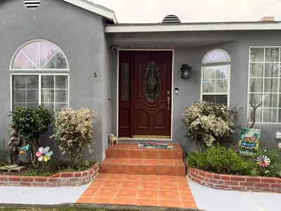 a house with a brown door and a staircase at Dream House Retreat LLC in Los Angeles