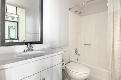 a white bathroom with a toilet and a sink at Blueground Hollywood gym AC nr Runyon LAX-1344 in Los Angeles