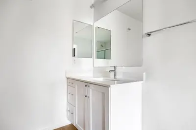 a white bathroom with a sink and a mirror at Blueground Playa del Rey pool nr Dockweiler LAX-1431 in Los Angeles