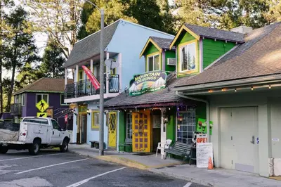 a street with a truck parked in front of buildings at Peaceful Mountain Sanctuary near Arrowhead Village in Lake Arrowhead