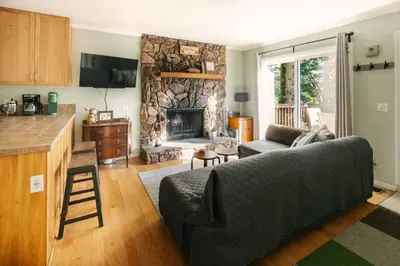 a living room with a couch and a fireplace at Peaceful Mountain Sanctuary near Arrowhead Village in Lake Arrowhead