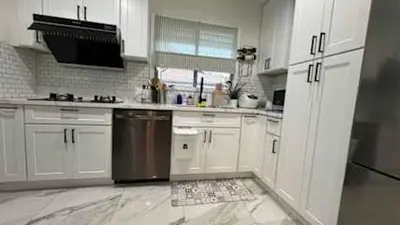 a kitchen with white cabinets and stainless steel appliances at Charming 2B2B Retreat in Temple City in Temple City