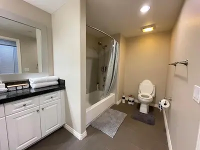 a bathroom with a shower and a toilet and a sink at Spacious 2 Bed, 2-Bath Apartment in Monterey Park in Monterey Park