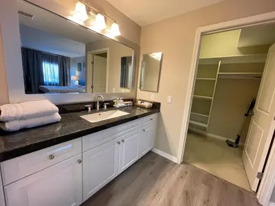 a bathroom with a sink and a large mirror at Spacious 2 Bed, 2-Bath Apartment in Monterey Park in Monterey Park
