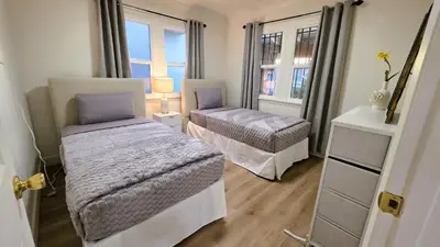 a bedroom with two beds and a window at Renovated Three Bedroom Near Cedars Sinai and Beverly Hills With Parking in Los Angeles