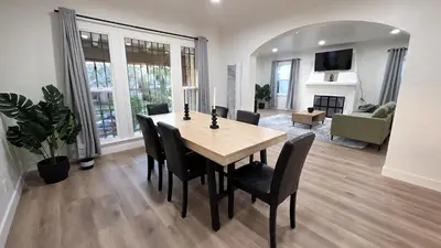 a dining room table and chairs in a living room at Renovated Three Bedroom Near Cedars Sinai and Beverly Hills With Parking in Los Angeles