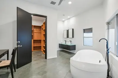 a bathroom with a white tub and a sink at Hollywood Hills Luxury Nest Views Pool Spa in Los Angeles
