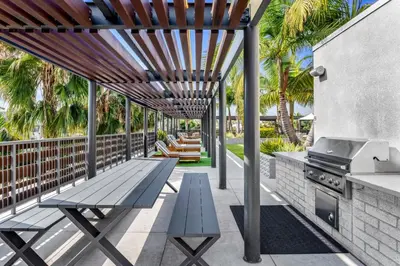 a patio with a picnic table and a grill at Runway Playa Vista in Los Angeles