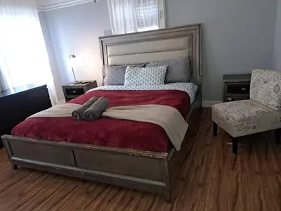 a bedroom with a large bed and a chair at Amazing 3 bedrooms with 3 bedroom apt in the center of Beverly Hills in Los Angeles