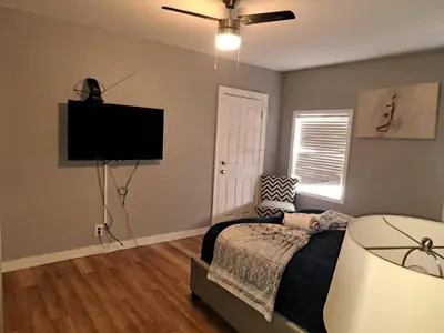 a bedroom with a bed and a flat screen tv at Amazing 3 bedrooms with 3 bedroom apt in the center of Beverly Hills in Los Angeles