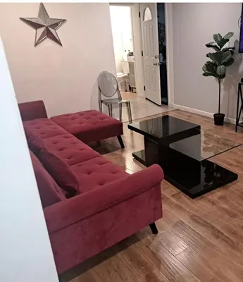 a living room with a red couch and a table at 1 bedroom spacious apt in Beverly hills in Los Angeles