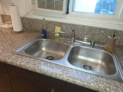 a stainless steel sink in a kitchen with a window at 1 bedroom spacious apt in Beverly hills in Los Angeles