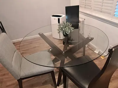 a glass table with two chairs and a vase with flowers at 1 bedroom spacious apt in Beverly hills in Los Angeles