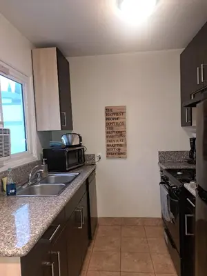 a kitchen with a sink and a microwave at 1 bedroom spacious apt in Beverly hills in Los Angeles