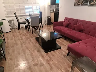 a living room with a red couch and a table at 1 bedroom spacious apt in Beverly hills in Los Angeles