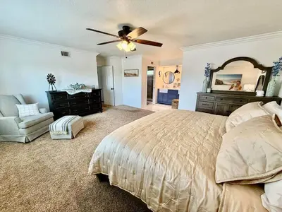 a bedroom with a bed and a ceiling fan at Peace of Paradise - Heated Pool, Spa & Fireplace in Simi Valley