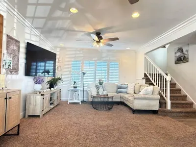a living room with a couch and a ceiling fan at Peace of Paradise - Heated Pool, Spa & Fireplace in Simi Valley