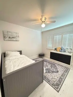 a bedroom with a bed and a ceiling fan at Peace of Paradise - Heated Pool, Spa & Fireplace in Simi Valley