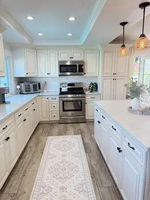 a kitchen with white cabinets and a stove top oven at Peace of Paradise - Heated Pool, Spa & Fireplace in Simi Valley