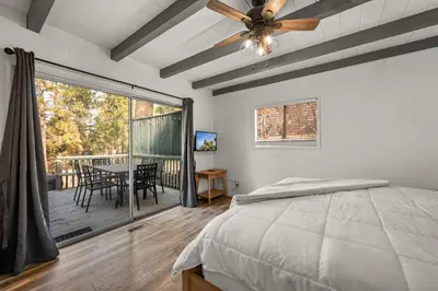 a bedroom with a bed and a ceiling fan at Mockingbird Retreat - Walk to the Lake, hot tub, EV charger, Fenced yard. in Big Bear Lake
