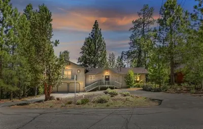 a large house with a driveway in front at Mockingbird Retreat - Walk to the Lake, hot tub, EV charger, Fenced yard. in Big Bear Lake