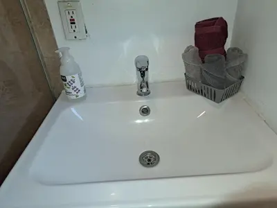 a bathroom sink with a soap bottle and a soap dispenser at Charming 1 bedroom apt in Beverly Hills in Los Angeles