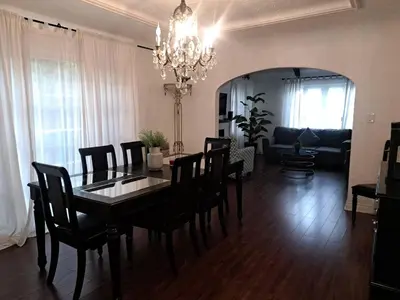 a dining room with a table and chairs and a living room at 3 bedroom plus 2 baths in Beverly hills in Los Angeles