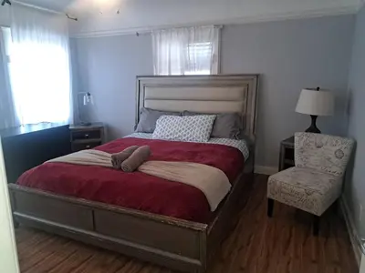 a bedroom with a large bed and a chair at 3 bedroom plus 2 baths in Beverly hills in Los Angeles