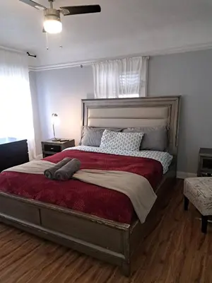 a bedroom with a large bed with a red blanket at 3 bedroom plus 2 baths in Beverly hills in Los Angeles