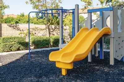 a yellow slide at a playground at Newly Remodeled 2BR Apt | Mins to Disney | Arcade in Placentia