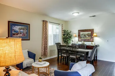 a living room with a table and a dining room at BBQ Ready Home 7 Mi to The Park at River Walk in Bakersfield
