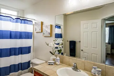 a bathroom with a sink and a mirror at BBQ Ready Home 7 Mi to The Park at River Walk in Bakersfield