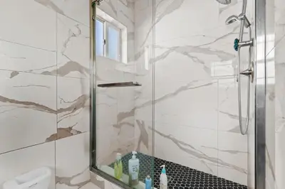 a bathroom with a shower with a glass door at Luxury Pool Oasis- Near Stadium, Tennis and Golf in Pasadena