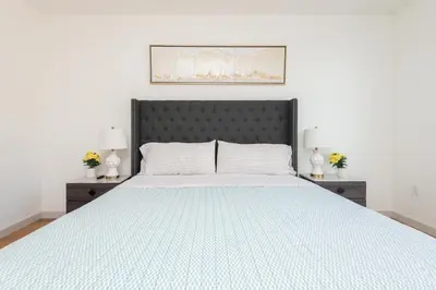 a bedroom with a large bed with two night stands at Modern Hollywood Apt with Pool Spa & Great Views in Los Angeles