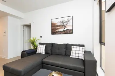 a living room with a couch and a picture on the wall at Walk to Santa Monica Beach & Pier Boardwalk in Los Angeles