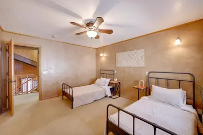 a bedroom with two beds and a ceiling fan at Mtn and Valley Views! Rimforest Lodge with Fireplace in Rimforest