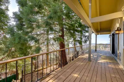 a wooden porch with a tree on it at Mtn and Valley Views! Rimforest Lodge with Fireplace in Rimforest