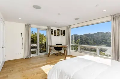 a bedroom with a bed and a desk and large windows at Spacious 4BR Retreat with Private Pool, Pool Table and Fast Wi-Fi Sleeps 9 Quiet Clinton Location in Beverly Hills