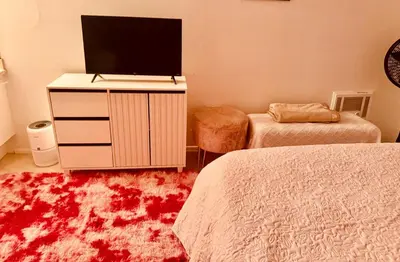 a bedroom with two beds and a tv on a dresser at Cozy beautiful 2 bedroom home at the beach in Los Angeles