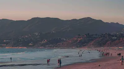 a group of people on a beach near the water at Cozy beautiful 2 bedroom home at the beach in Los Angeles