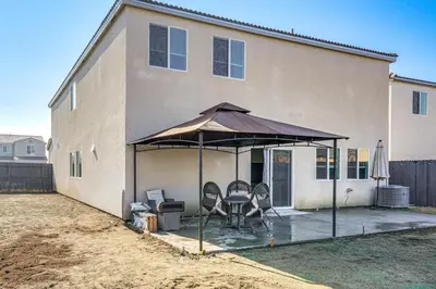 a patio with a table and chairs under a tent at Pet-Friendly Yard! Family Home in Bakersfield in Bakersfield