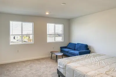 a bedroom with a blue chair and a bed at Pet-Friendly Yard! Family Home in Bakersfield in Bakersfield
