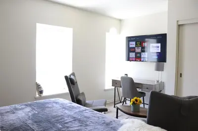 a bedroom with a bed and a desk and a tv at Promenade Studio With Free Parking in Los Angeles