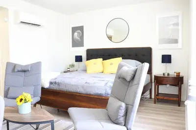 a bedroom with a bed and a chair and a table at Promenade Studio With Free Parking in Los Angeles