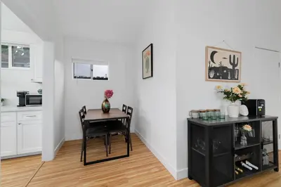 a dining room with a table and a kitchen at Mar Vista 2BR Retreat Office Huge Backyard in Los Angeles
